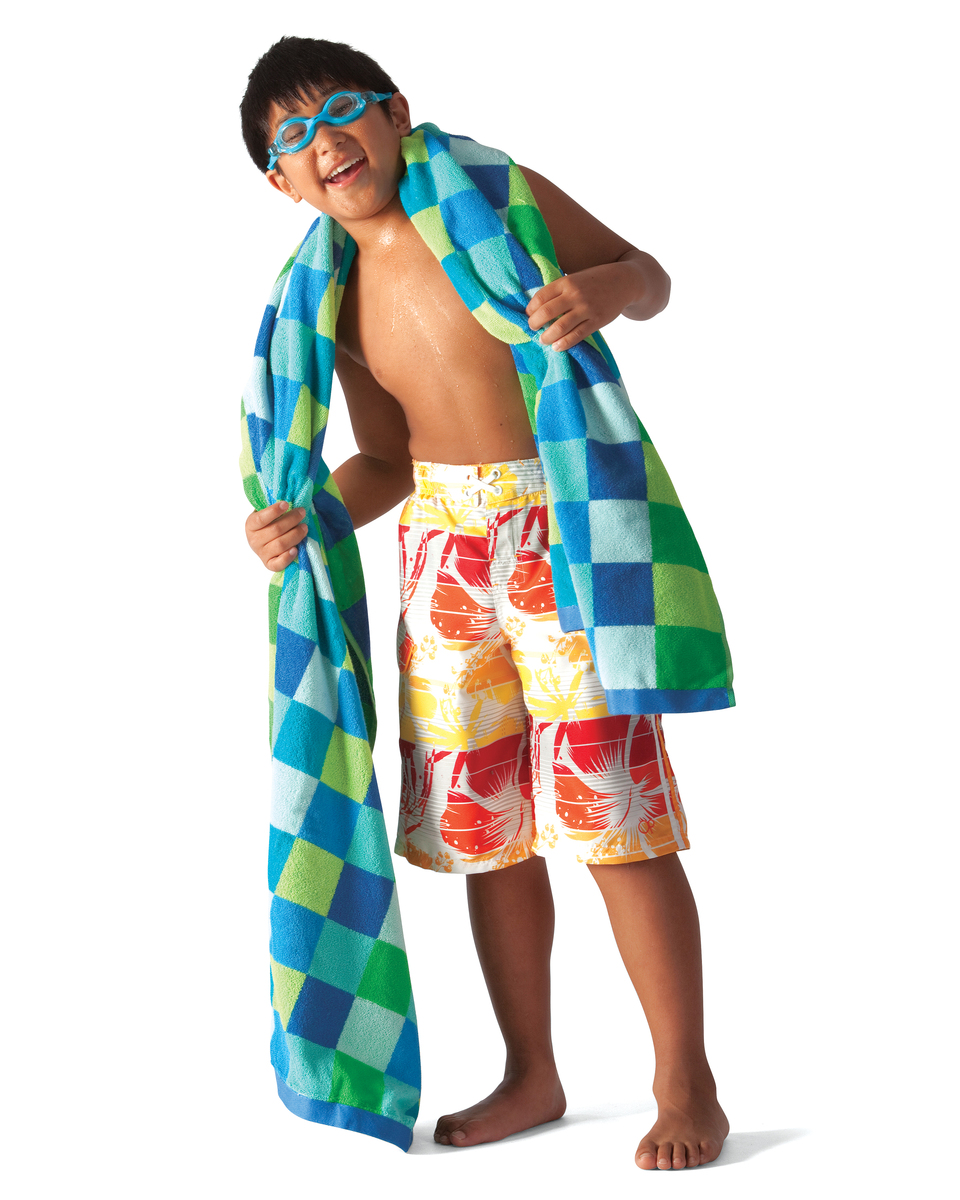 Young boy in swimsuit with towel.